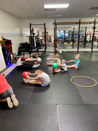 Kids stretching in a gym